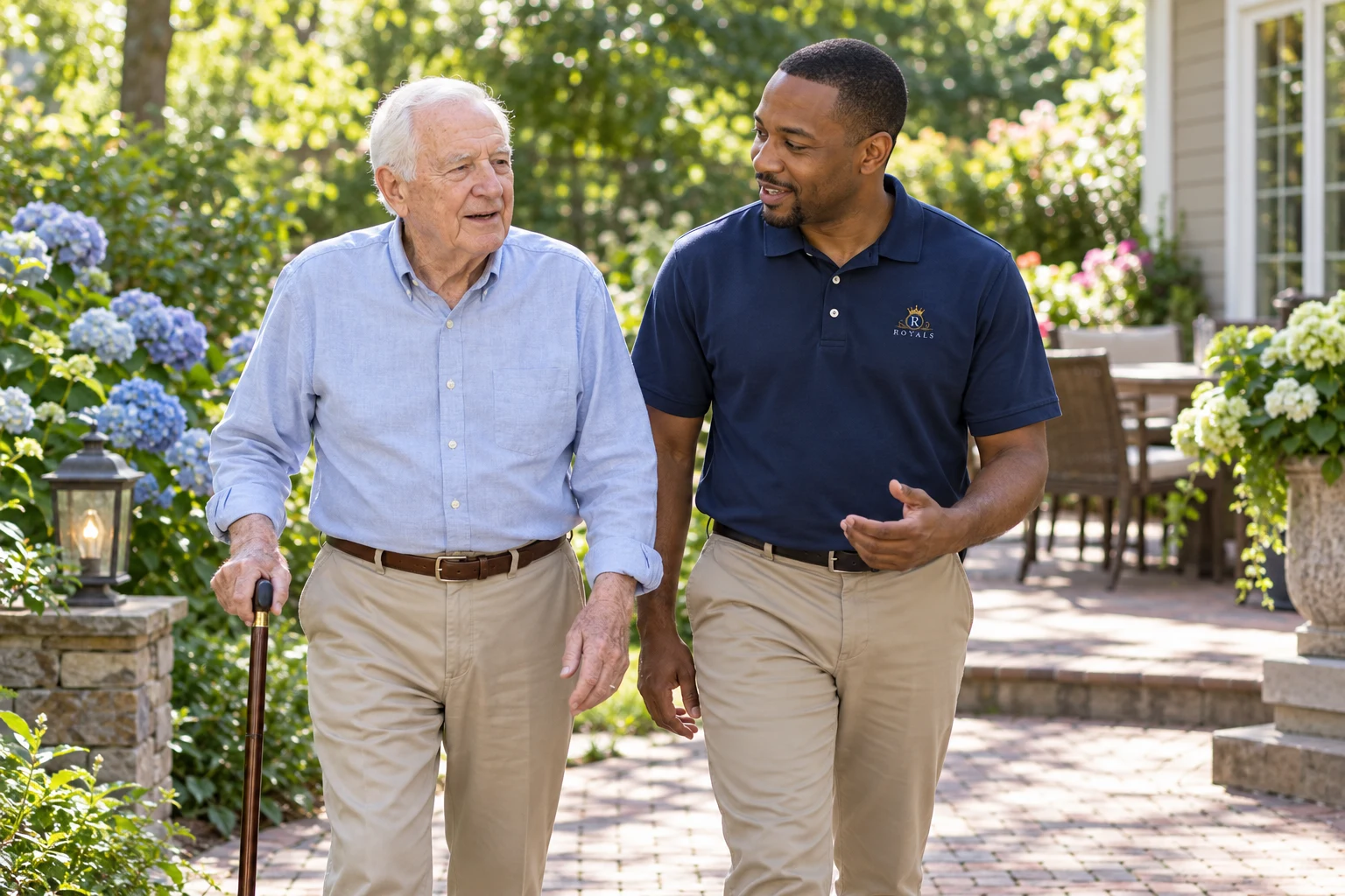An older adult and caregiver enjoying a conversation in a garden